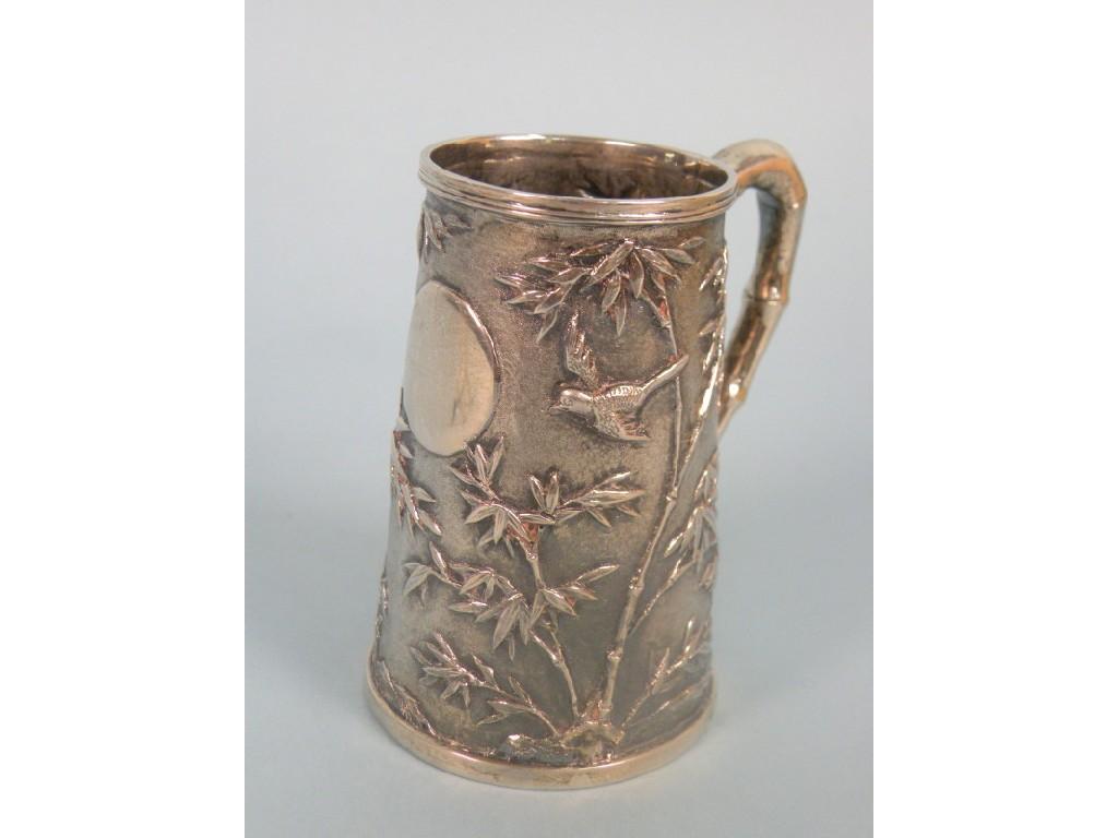 Appraisal: A Chinese silver christening mug decorated overall with birds and