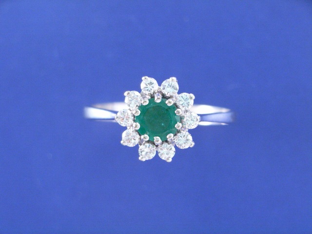 Appraisal: An ct white gold emerald and diamond cluster ring estimated