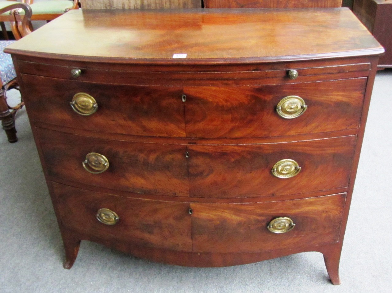 Appraisal: An early th century mahogany bowfront chest the brushing slide