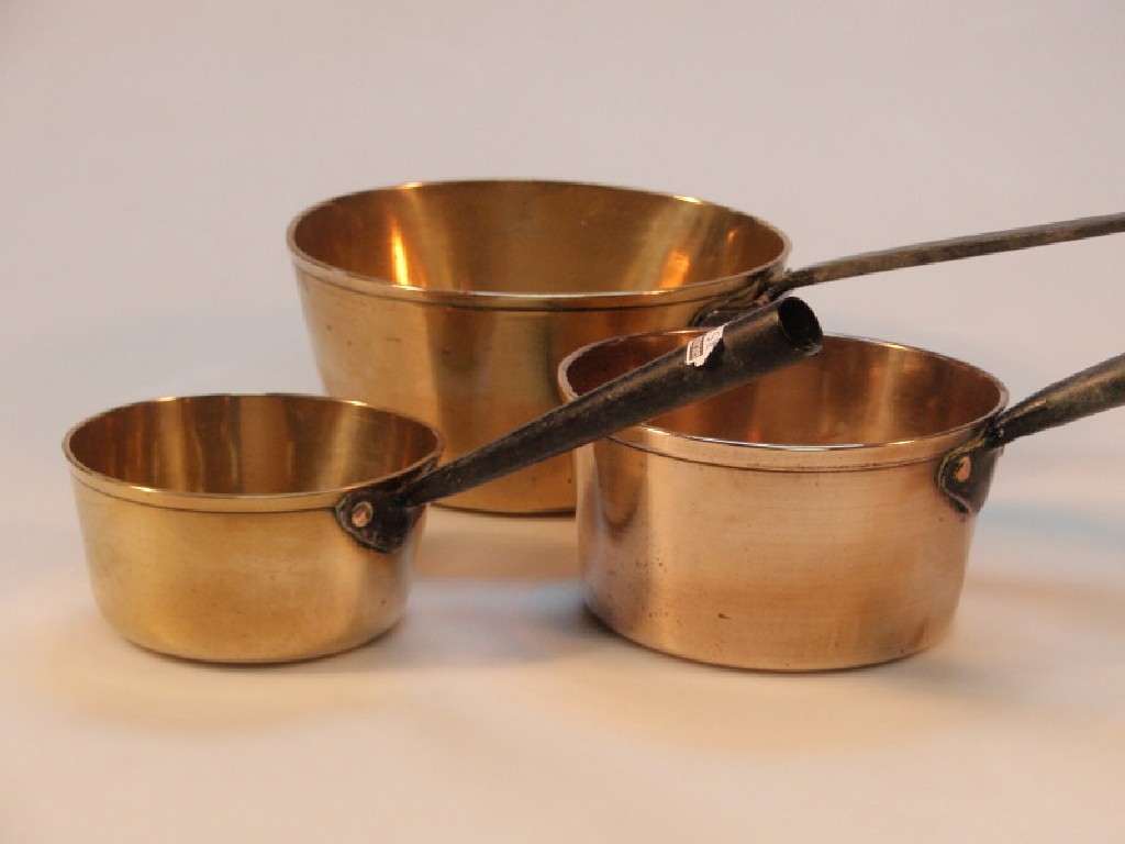 Appraisal: Two old brass saucepans and an old brass copper saucepan