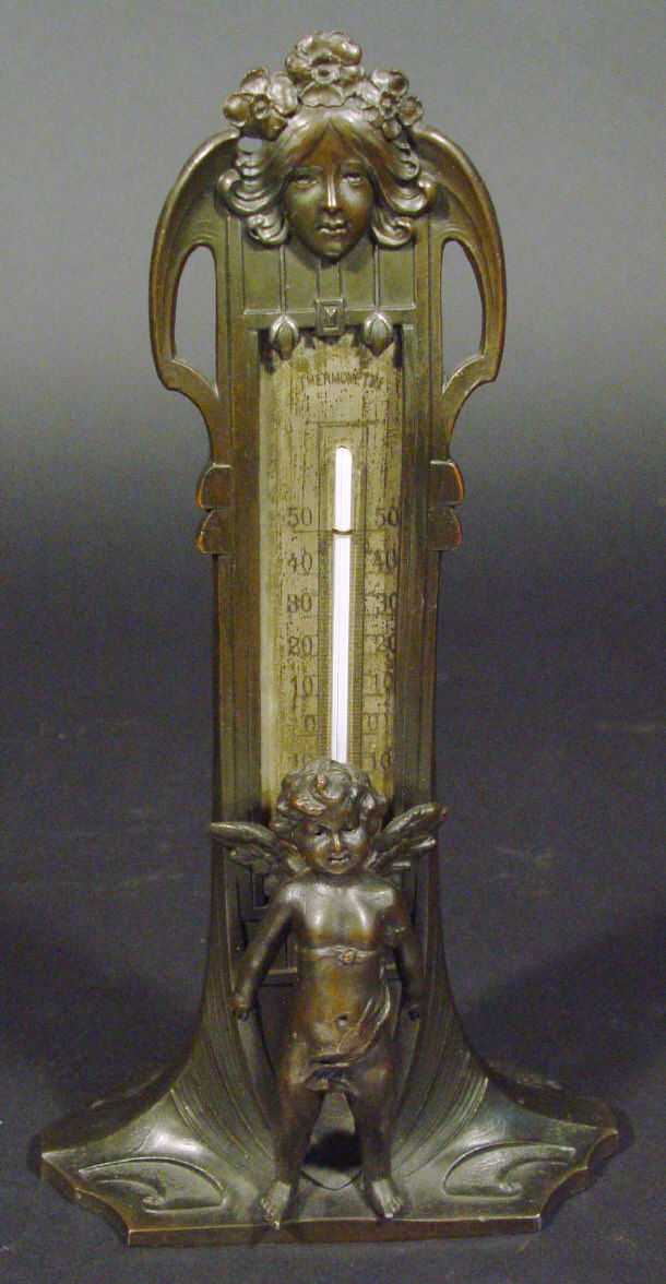 Appraisal: Art Nouveau cast metal thermometer with silvered panel the surround