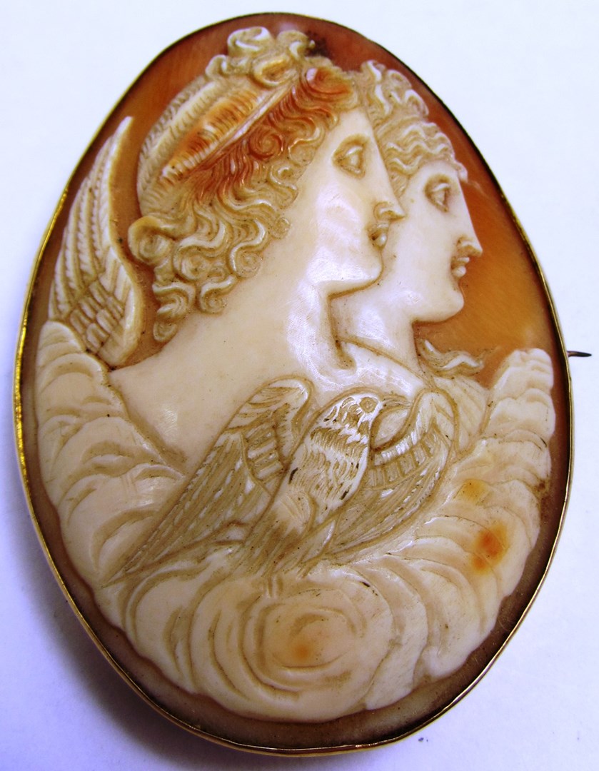 Appraisal: A gold mounted oval shell cameo brooch carved as two