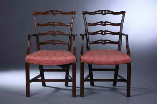 Appraisal: PAIR CHIPPENDALE STYLE MAHOGANY LADDER-BACK OPEN-ARM CHAIRS th century Carved