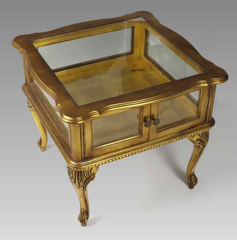 Appraisal: GILT WOOD CURIO DISPLAY TABLE Shaped top with glass inset