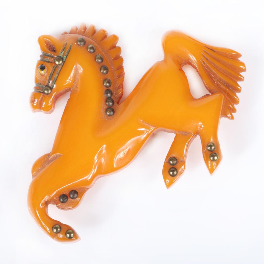 Appraisal: VINTAGE BAKELITE EQUESTRIAN FIGURAL PRANCING HORSE BROOCH IN CARVED BUTTERSCOTCH