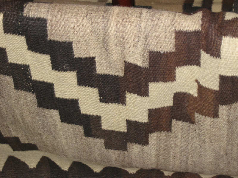 Appraisal: NAVAJO BLANKET The natural tan field shows a pair saw