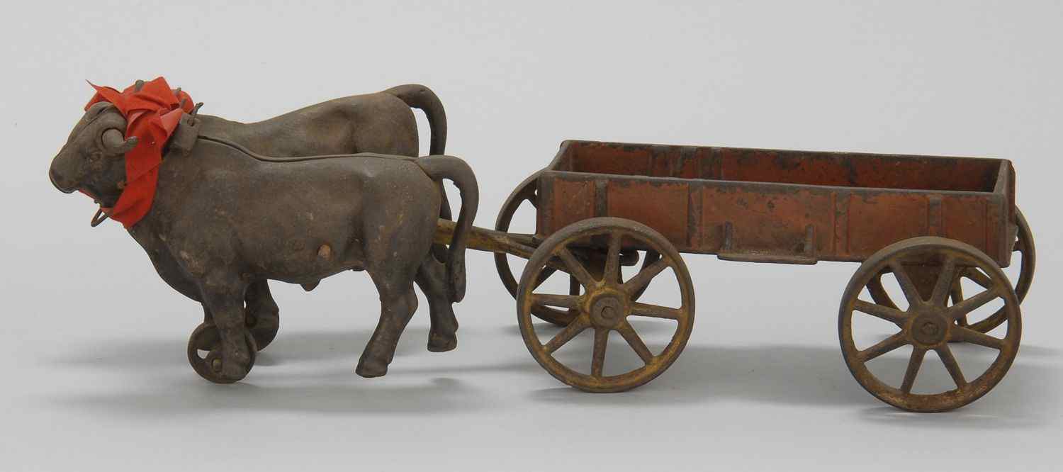 Appraisal: CAST IRON DOUBLE OX CART PULL TOYLate th CenturyDepicting two