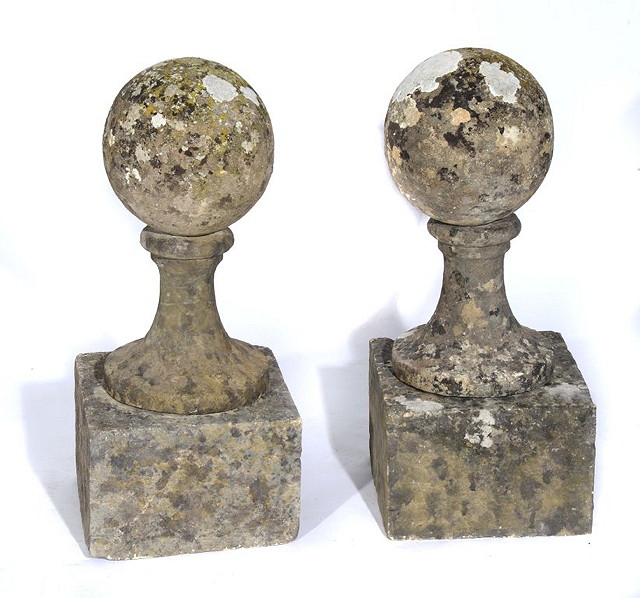 Appraisal: A PAIR OF STONE FINIALS each on a square base