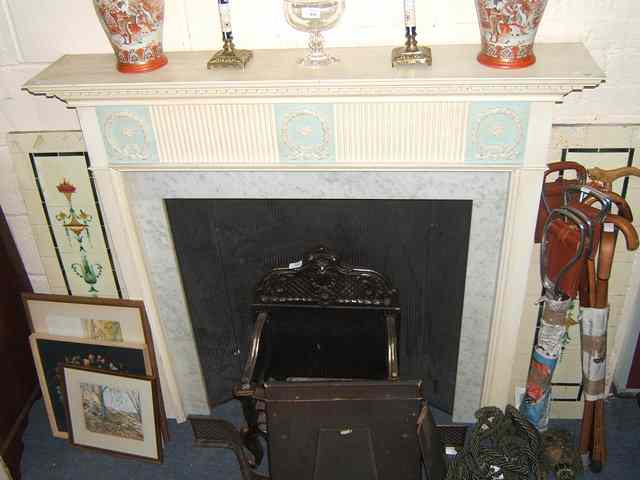 Appraisal: A WHITE PAINTED GEORGIAN STYLE FIRE SURROUND with marble slips