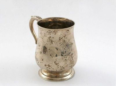 Appraisal: A George III small baluster mug leaf capped scroll handle