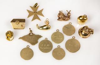 Appraisal: Collection of yellow gold charms Collection of yellow gold charms