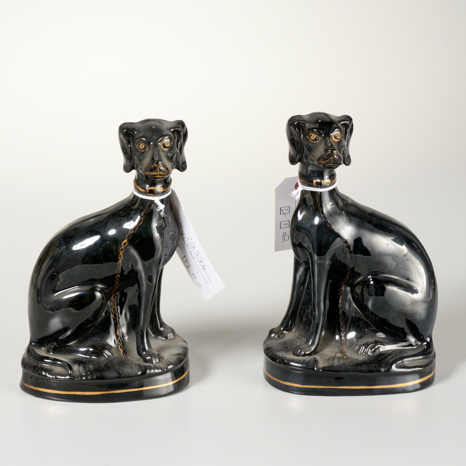 Appraisal: PAIR JACKFIELD STAFFORDSHIRE DOG FIGURES th c black glazed Staffordshire