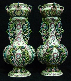 Appraisal: A pair of Zsonlay Fischer baluster reticulated twin handled vases