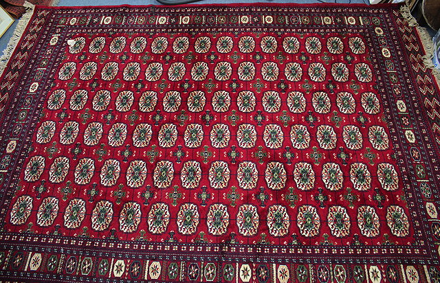 Appraisal: A LARGE RED GROUND MIDDLE EASTERN CARPET cm x cm