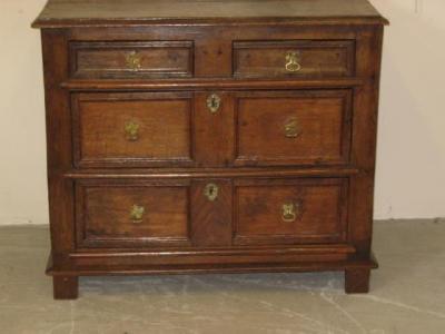 Appraisal: AN OAK CHEST with moulded edged top two short and