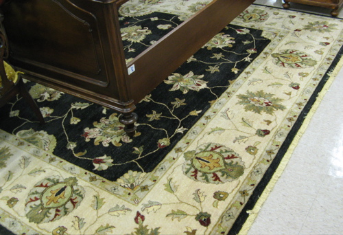 Appraisal: HAND KNOTTED ORIENTAL CARPET Persian floral design on rectangular black