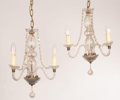 Appraisal: A pair of cut glass three-light chandeliers with spiral branches