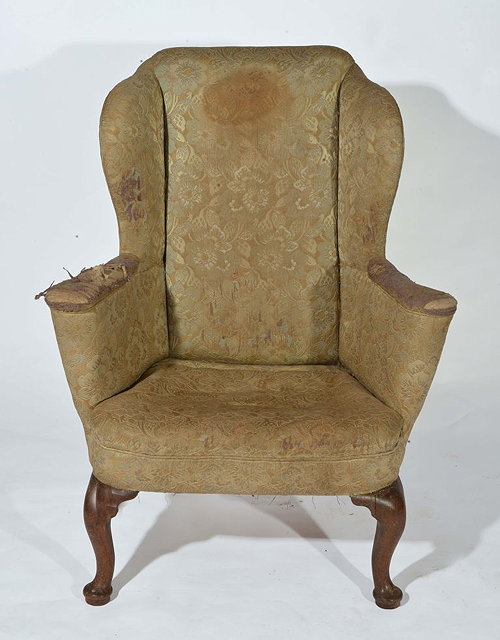 Appraisal: AN TH CENTURY WALNUT FRAMED WING ARMCHAIR with cabriole supports