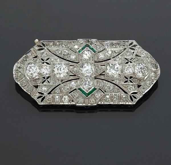 Appraisal: A diamond and synthetic emerald brooch estimated total diamond weight