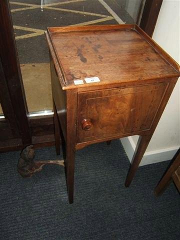 Appraisal: A Georgian mahogany pot cupboard with square tapering legs wide