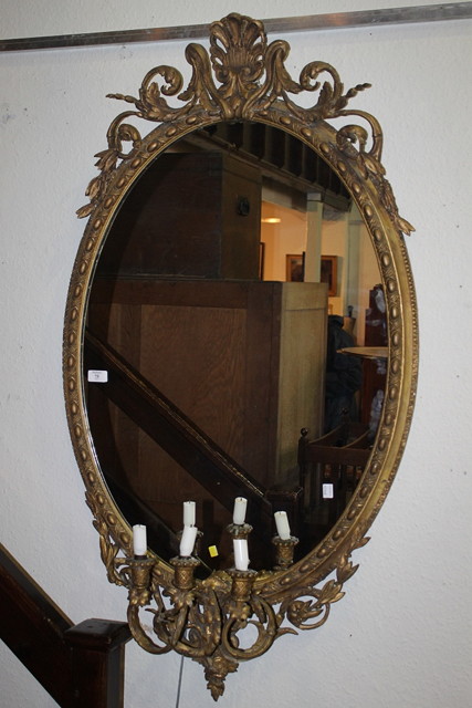 Appraisal: A VICTORIAN GILT FRAME OVAL GIRANDOLE WALL MIRROR with scroll