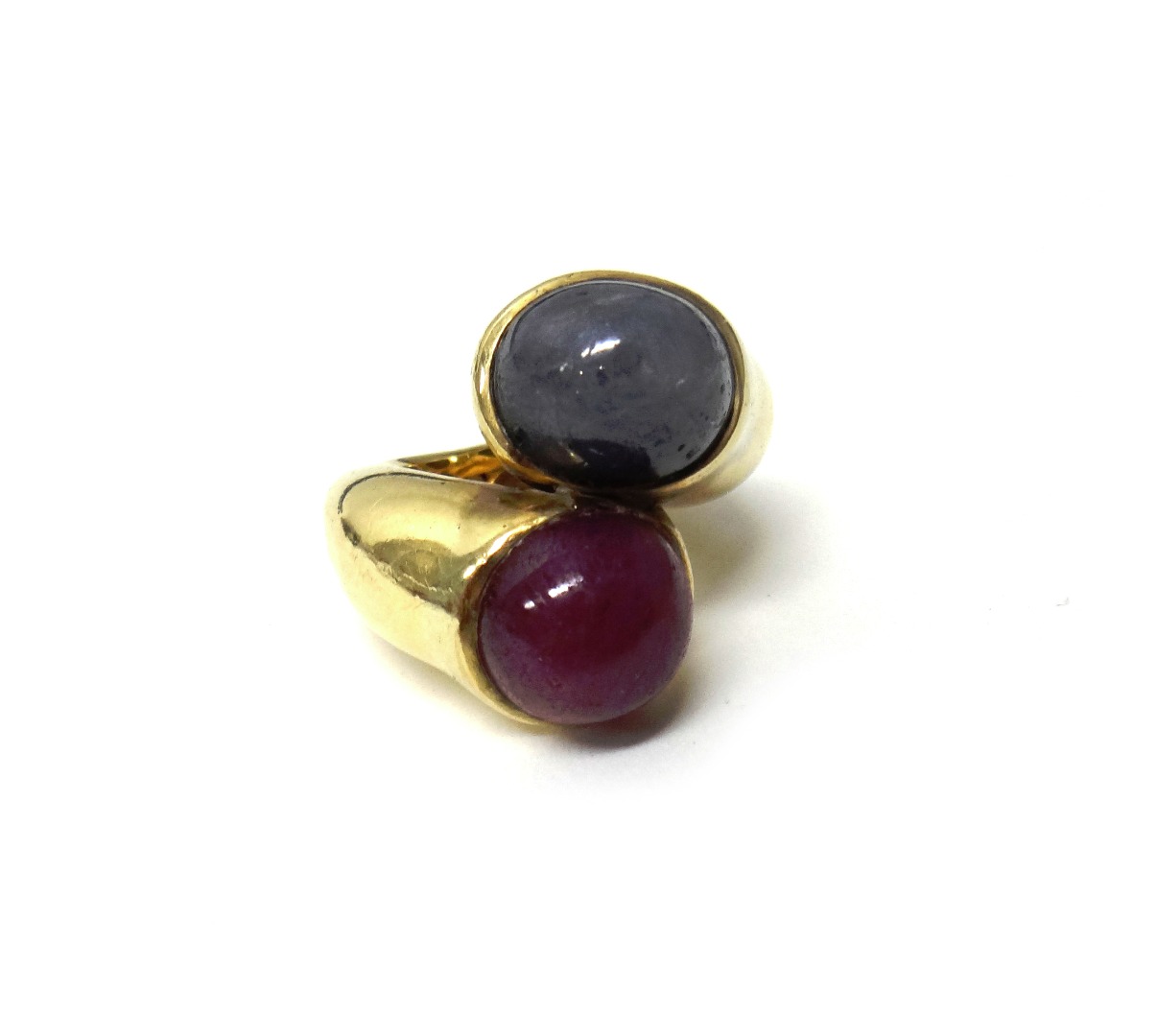 Appraisal: A gold cabochon sapphire and cabochon ruby set two stone