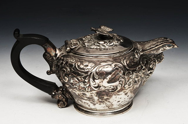 Appraisal: A SILVER TEAPOT of baluster form with turned wood handle