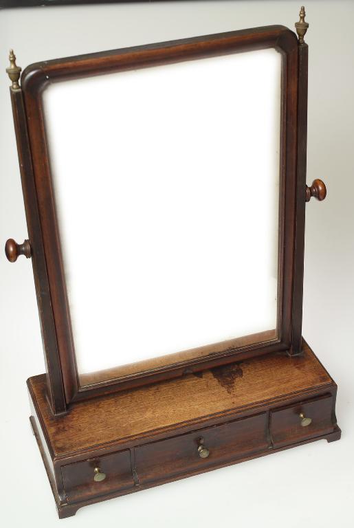 Appraisal: GEORGE III MAHOGANY TOILET MIRROR with cushion framed mirror brass