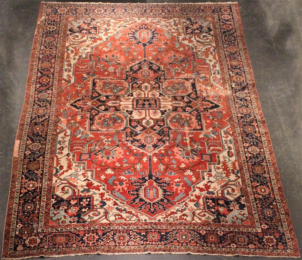 Appraisal: ANTIQUE HERIZ WOOL RUG central medallion design colors include rose