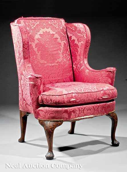 Appraisal: A George II-Style Carved Walnut Wing Chair shaped winged back