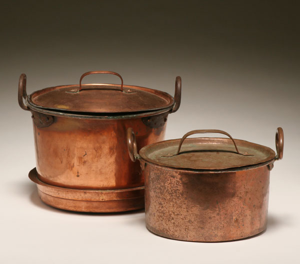 Appraisal: Two early copper pots with lids strap handles on lids