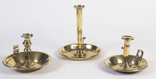 Appraisal: A group of three mid th century large brass chambersticks