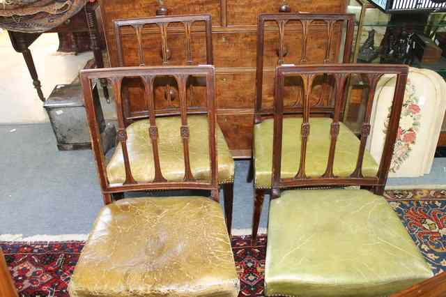 Appraisal: FOUR GEORGE III CARVED MAHOGANY DINING CHAIRS with slat sheaf