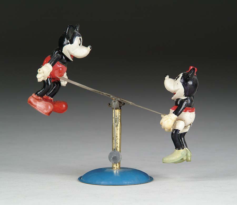 Appraisal: RARE CELLULOID MICKEY AND MINNIE SEESAW TOY Rubber band activated