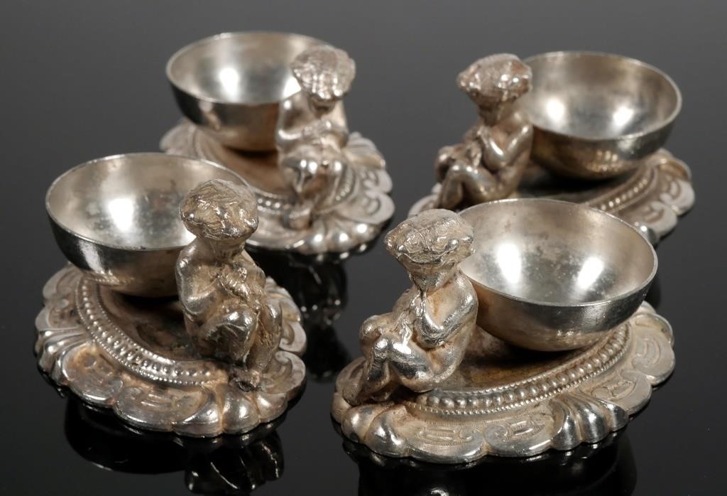 Appraisal: CONTINENTAL SILVERPLATE FIGURAL SALTSilverplate figural salt cellars with base basin