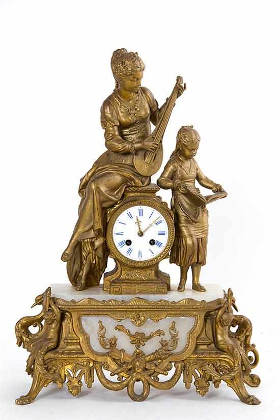 Appraisal: French gilt metal and marble figural mantel clock circa two