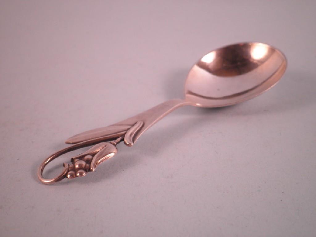 Appraisal: A Georg Jensen caddy spoon the handle decorated with a