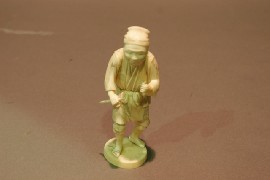 Appraisal: A Japanese ivory figure of a man with a flower