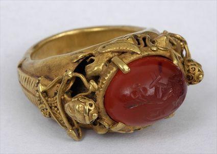 Appraisal: PERSIAN ORNATE GOLD RING SET WITH INTAGLIO INCISED WITH ANIMALS