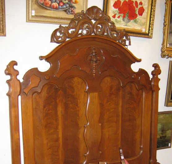 Appraisal: AMERICAN ROCOCO REVIVAL WALNUT BEDSTEAD The arched headboard centers a