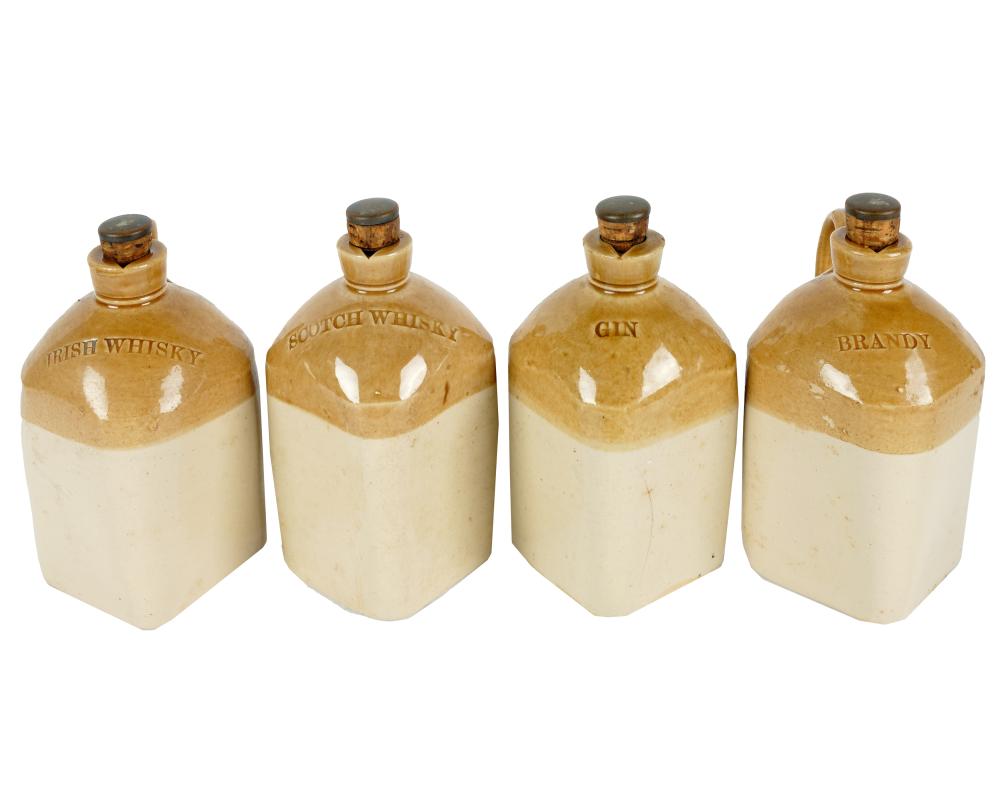 Appraisal: FOUR POTTERY LIQUOR JUGSunsigned with metal and cork stoppers each