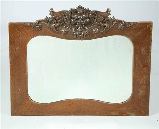 Appraisal: CARVED OAK MIRROR Large mirror with a carved face at