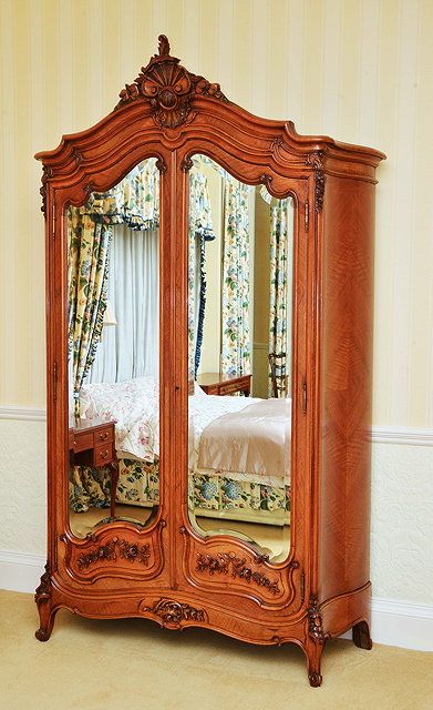 Appraisal: A LARGE FRENCH WALNUT ARMOIRE the arching top with central