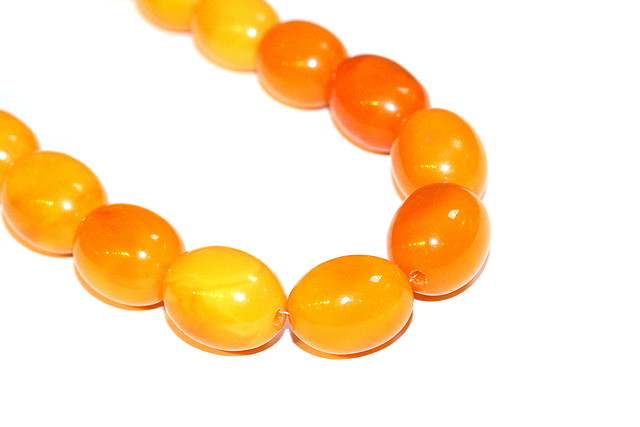 Appraisal: A BALKAN AMBER NECKLACE oval beads mm wide bead down