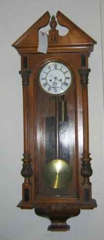 Appraisal: CONTINENTAL WALNUT REGULATOR WALL CLOCK Having an architectural pediment over