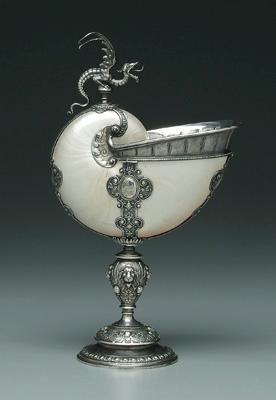 Appraisal: Silver mounted nautilus cup Continental silver with baluster stem lions