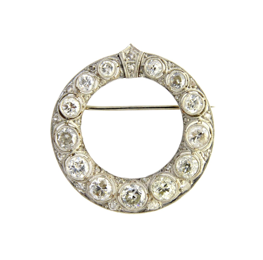 Appraisal: A diamond brooch in a circular openwork design mounted with