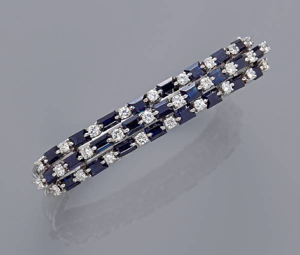 Appraisal: A sapphire and diamond bangle bracelet estimated total diamond weight