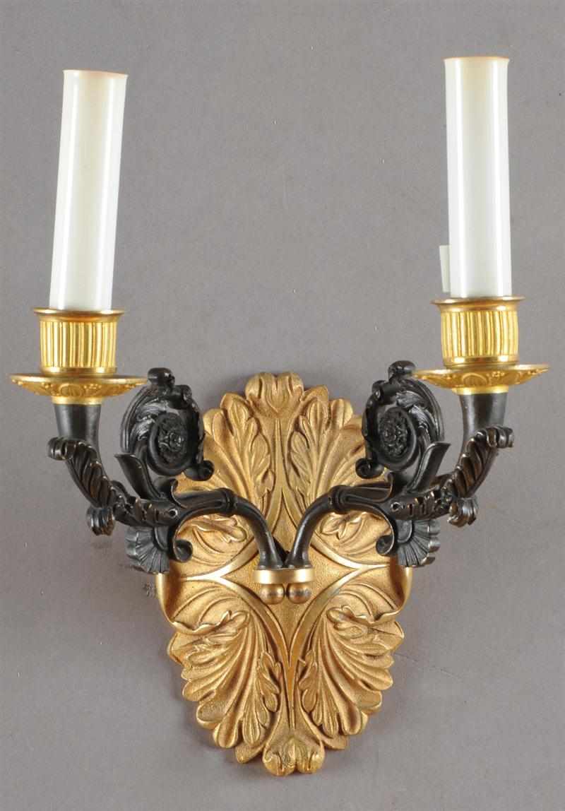 Appraisal: PAIR OF EMPIRE STYLE PATINATED AND GILT-BRONZE TWO-LIGHT WALL APPLIQUES