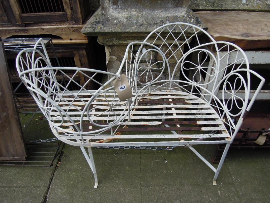 Appraisal: A decorative iron framed love seat conversation bench with shaped